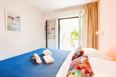 a bedroom with a bed with towels on it at PALAIS LIBERTE V AP4267 By Riviera Holiday Homes in Nice