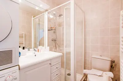 a bathroom with a shower and a toilet and a sink at PALAIS LIBERTE V AP4267 By Riviera Holiday Homes in Nice