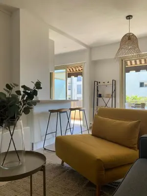 a living room with a couch and a table at Habana in Saint-Laurent-du-Var