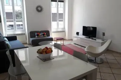 a living room with a couch and a table at Spacious Appartment Wifi Next To The Port in Nice