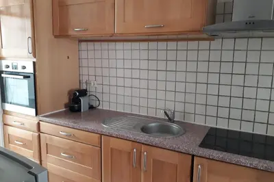 a kitchen with a sink and a tiled wall at Spacious Appartment Wifi Next To The Port in Nice