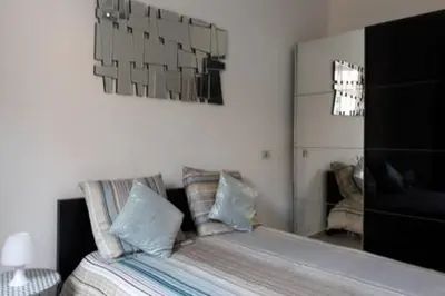 a bedroom with a bed with pillows and a mirror at Spacious Appartment Wifi Next To The Port in Nice