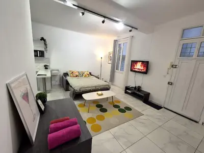 a living room with a couch and a table at Studio rénové au centre ville (15 min de la plage) in Nice