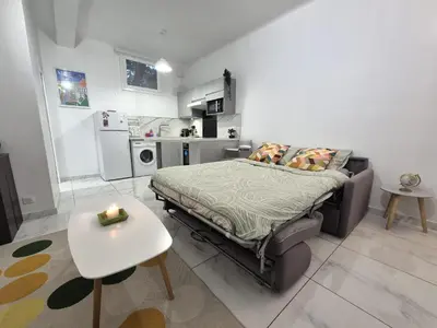 a small bedroom with a bed and a table at Studio rénové au centre ville (15 min de la plage) in Nice