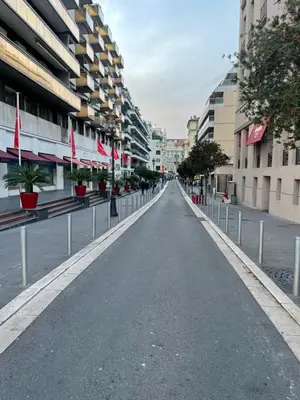 an empty street with flags in the middle of a city at Apart Nissa Bella Centre / Promenade des Anglais in Nice