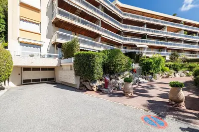a building with a lot of bushes and a driveway at Extraordinary Sea View - 1 Bdr with AC in Villefranche-sur-Mer