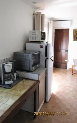 a kitchen with a microwave on top of a refrigerator at NICE - STUDIO indépendant en VILLA - Mer ville calme jardinet in Nice
