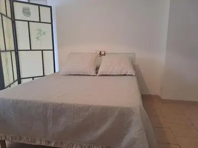 a bed with two pillows on it in a room at Loft 2 in La Trinité