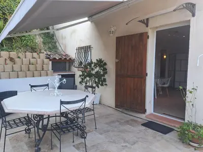 a patio with a table and chairs and a door at Loft 2 in La Trinité