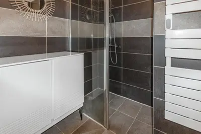 a bathroom with a shower with a glass door at Le Pied Dans L'eau - Parking - Seaside - Hipprodrome in Cagnes-sur-Mer