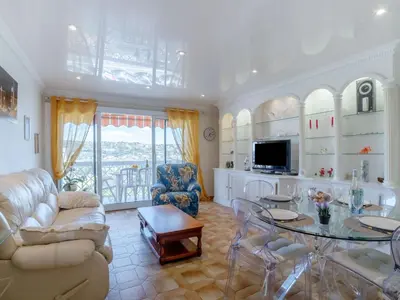 a living room with a couch and a table at Apartment Le Giono by Interhome in Saint-Laurent-du-Var