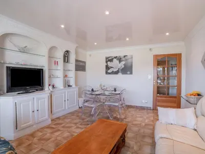 a living room with a couch and a table at Apartment Le Giono by Interhome in Saint-Laurent-du-Var
