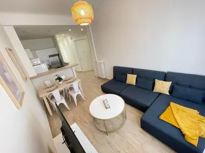 a living room with a blue couch and a table at Nice Renting - Penchienatti - Spacious Apartment - 2 BedRooms - King Bed - View Heart of Nice in Nice