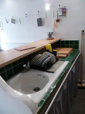 a kitchen counter with a white sink and green tiles at Joli 3 pièces, 7 pers, très lumineux, Nice centre in Nice