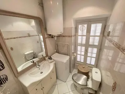 a white bathroom with a sink and a toilet at Nice Renting - 9 MASSENA - Spacious apartment Massena Square - AC - fully equipped in Nice