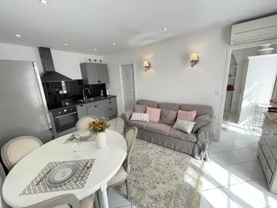 a living room with a table and a couch at Nice Renting - 9 MASSENA - Spacious apartment Massena Square - AC - fully equipped in Nice