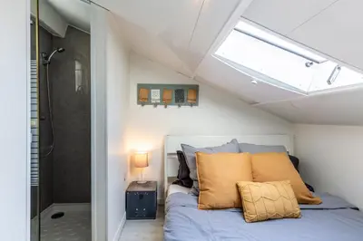 a bedroom with a bed and a shower at Homelivia, ATTIC ROOM -Mansardé sous les toits de Nice in Nice
