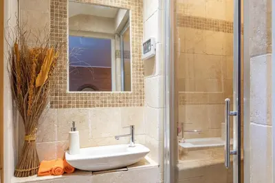 a bathroom with a sink and a mirror at Harmonice in Cantaron
