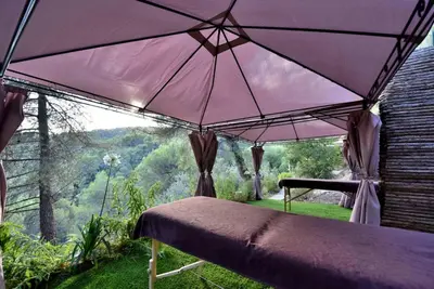 a bed with a purple canopy with a view at Harmonice in Cantaron
