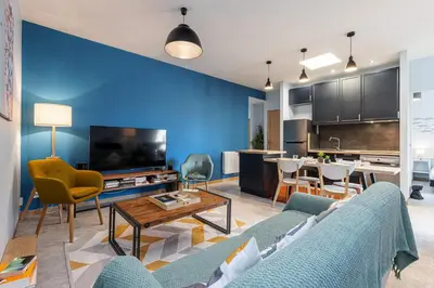 a living room with a couch and a table at Large 3 Bdr City Center in Nice