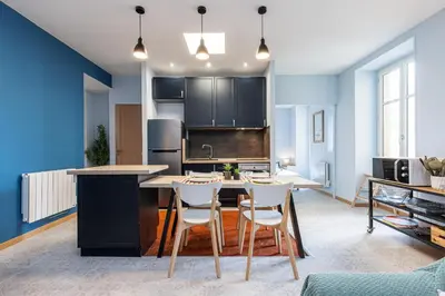 a kitchen with a table and chairs in a room at Large 3 Bdr City Center in Nice