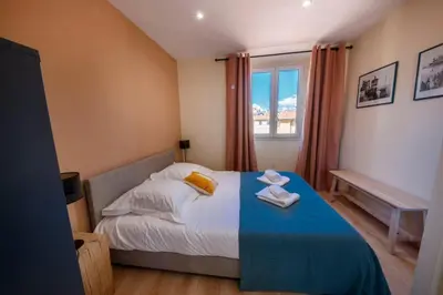 a bedroom with a bed with a blue blanket and a window at 06A2 - Heart of Old Nice beautiful renovated apartment in Nice