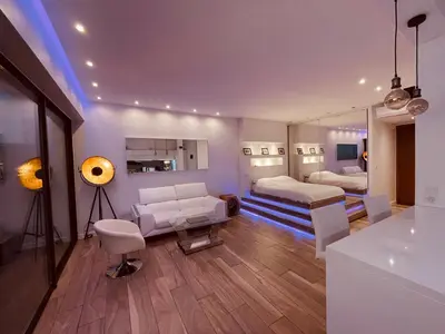 a living room with two beds and a mirror at SEA VIEW TOP FLOOR - PROMENADE DES ANGLAIS in Nice