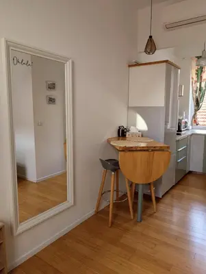 a mirror in a room with a table and a kitchen at Herold Riviera in Nice
