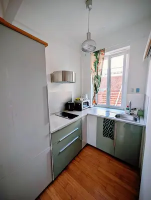 a small kitchen with a sink and a refrigerator at Herold Riviera in Nice