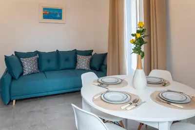 a living room with a white table and a blue couch at Lovely apartment with terrace Nice centre in Nice