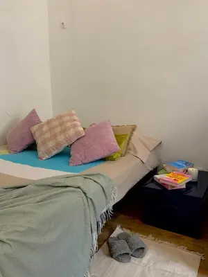 a bed with pillows on it in a room at AM STUDIO NICE in Nice