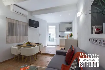 a living room with a couch and a table and a kitchen at PRIVATE BUILDING, 4 APTS, UNIQUE AT NICE- OLD TOWN in Nice