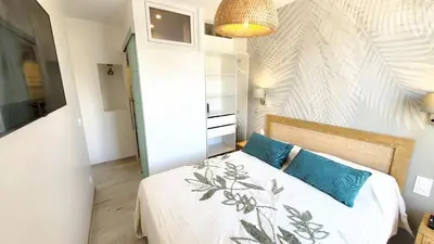 a bedroom with a bed with blue pillows on it at Ze Perfect Place - Opera Nice - Appartement 2 Chb - AC - Terrasse in Nice