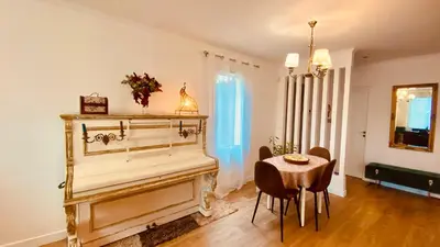a room with a piano and a table and chairs at Villa Canarias in Saint-Jeannet