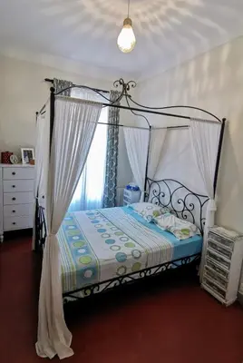 a bedroom with a bed with a canopy at Our home, Cozy Apartment two minutes from the sea - Clima in Nice