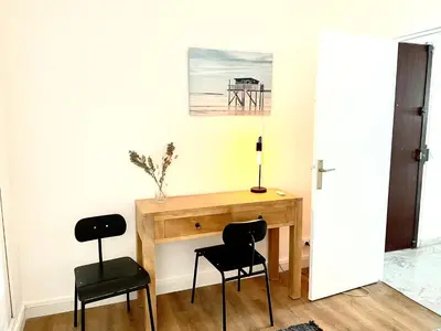a room with a desk and two chairs at Plage Landsberg - Saint-Laurent-du-Var in Saint-Laurent-du-Var