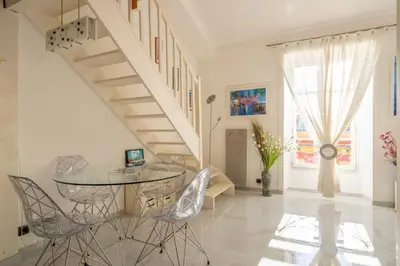 a dining room with a glass table and chairs at Stunning Duplex place Masséna 2 mins walk from beaches in Nice