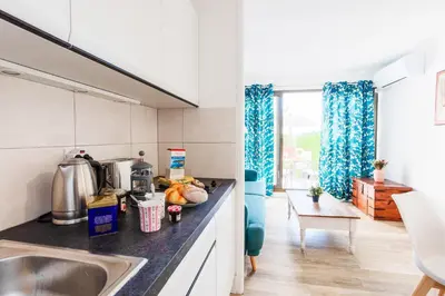 a kitchen with a sink and a counter top at L'ANGE GARDIEN III AP4293 By Riviera Holiday Homes in Villefranche-sur-Mer