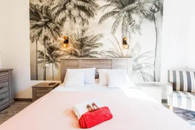 a bedroom with a white bed with a red towel at LE TIVOLI II AP4282 By Riviera Holiday Homes in Nice