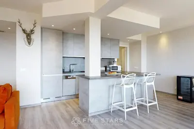 a kitchen with a counter and stools in a room at Suite Horizon FSHH in Beaulieu-sur-Mer