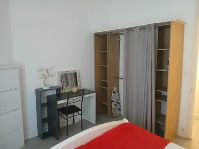 a bedroom with a desk and a bed and a closet at Bel appartement pour vos séjours sur la côte in Nice