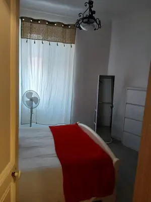 a bedroom with a bed with a red blanket on it at Bel appartement pour vos séjours sur la côte in Nice