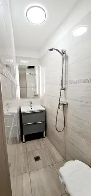 a white bathroom with a sink and a shower at ESPERANCE HOTEL in Nice