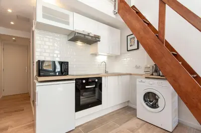 a kitchen with a washing machine and a washer and dryer at Maison Bianchi - Prefecture - Old Town in Nice