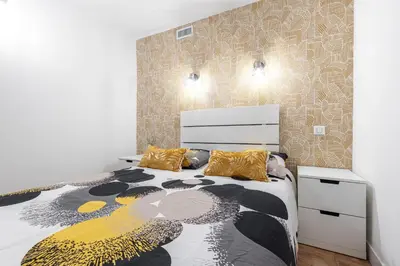 a bedroom with a bed with a black and yellow blanket at Loft Magnan - PARKING - idéal couples -BEACH -TRAM & Supermarkets - New & Confort-AC in Nice