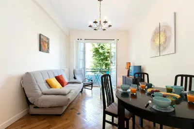 a living room with a table and a couch at Maison Bianchi - Victor Hugo in Nice