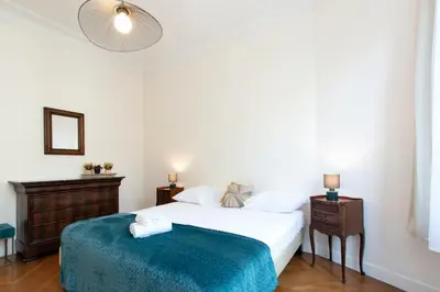 a bedroom with a bed and a nightstand and a bed at Maison Bianchi - Victor Hugo in Nice