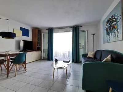 a living room with a couch and a table at Studio Le Grand Bleu Fshh in Nice
