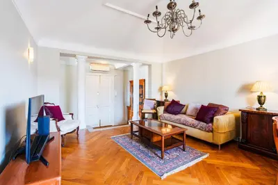a living room with a couch and a tv at LUNG ARNO AP4300 By Riviera Holiday Homes in Nice