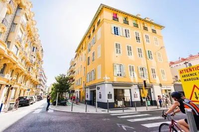 a yellow building on the side of a street at LUNG ARNO AP4300 By Riviera Holiday Homes in Nice